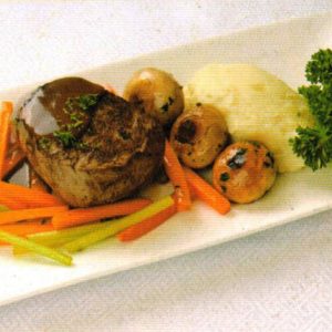 Pan-seared steak served with mashed potatoes and herb-infused mushrooms.